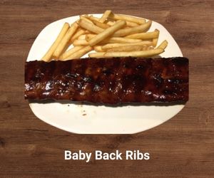 Fall-off-the-bone baby back ribs glazed with smoky BBQ sauce – tender and flavorful Outback Steakhouse entréeFall-off-the-bone baby back ribs glazed with smoky BBQ sauce – tender and flavorful Outback entrée
