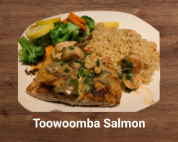 Toowoomba Salmon – grilled salmon fillet topped with creamy shrimp and mushroom sauce, served with seasoned vegetables – signature Outback Steakhouse seafood